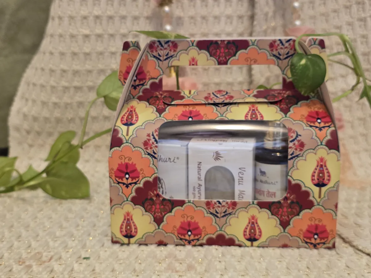The printed gift box packed, soap and oil visible through its window