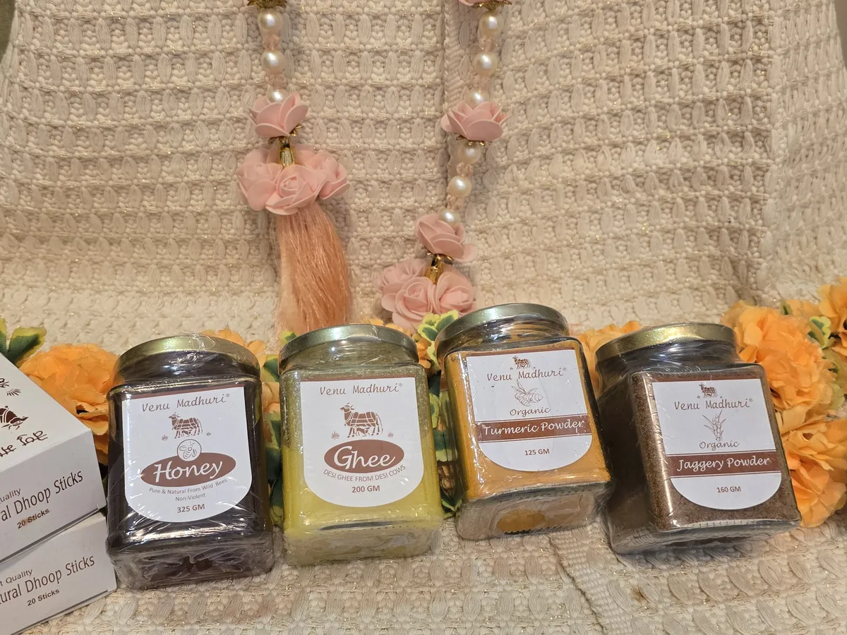 Four jars in a row: honey, ghee, turmeric powder and jaggery powder, with dhoop stick boxes beside them
