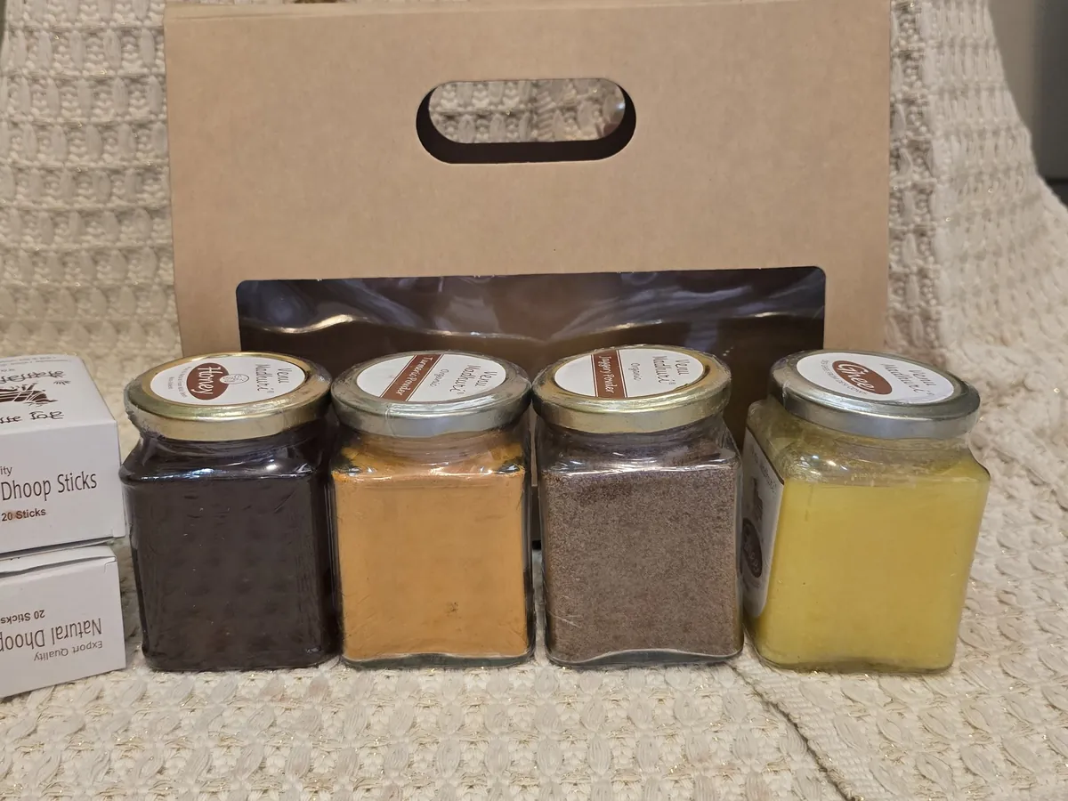 The four jars lined up in front of the kraft box