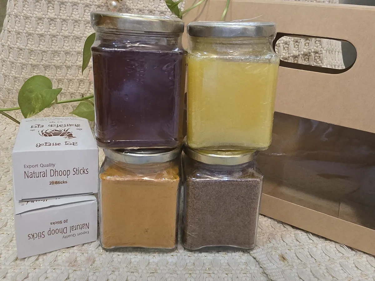 Jars stacked two by two next to two boxes of dhoop sticks